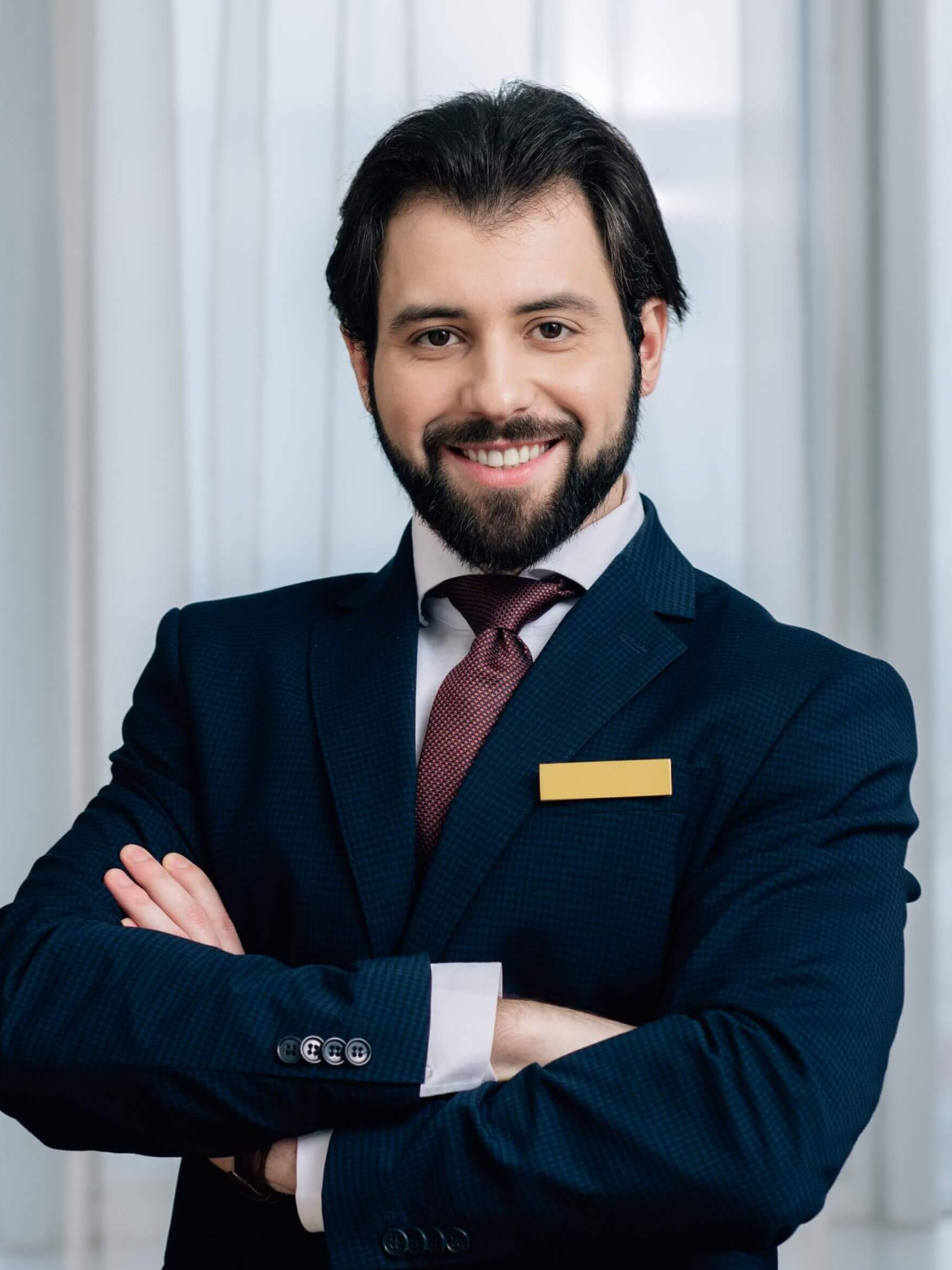 handsome-hotel-administrator-with-crossed-arms-loo-2024-11-17-13-39-25-utc-1.jpg